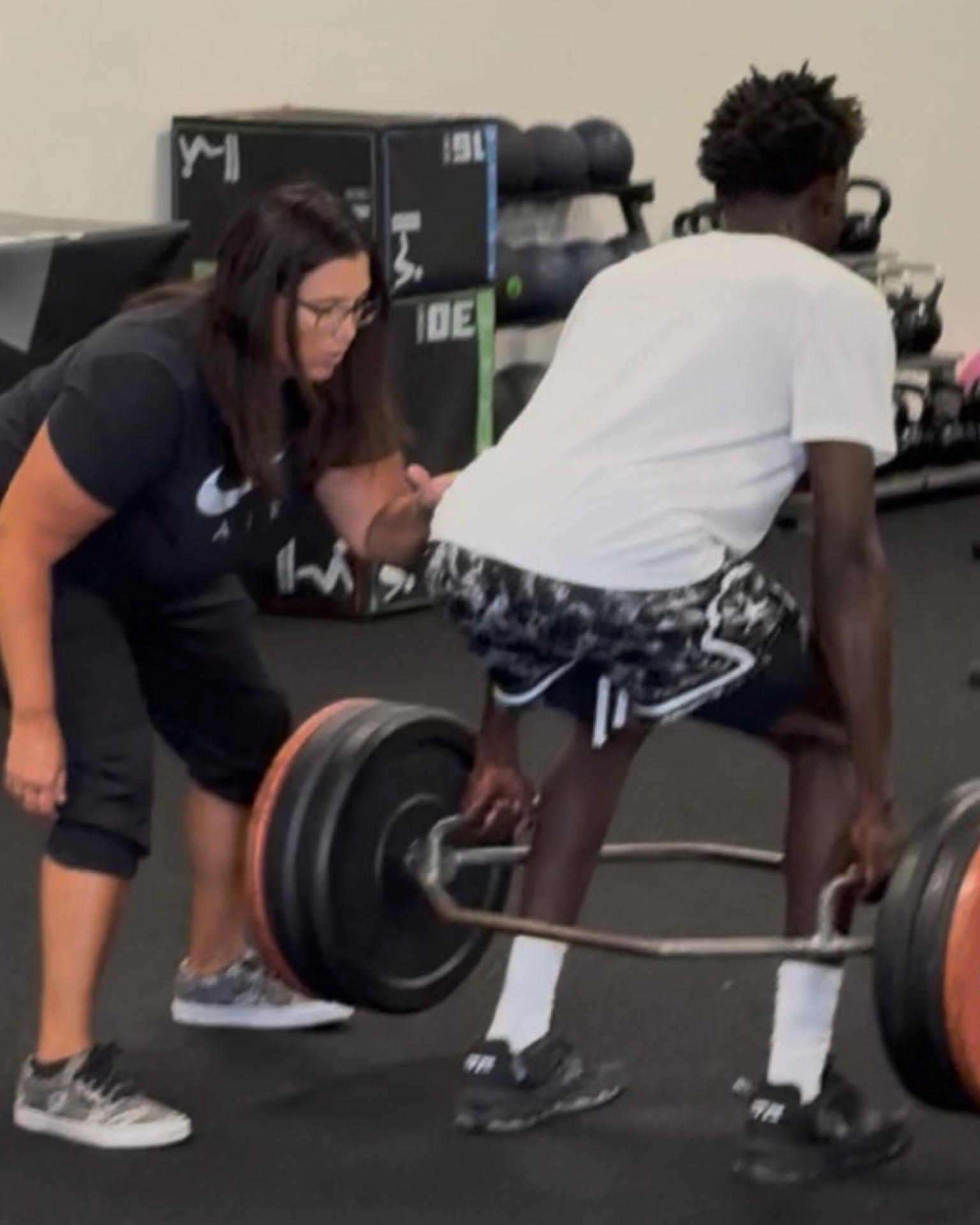 Hands-on coaching during a trap-bar deadlift