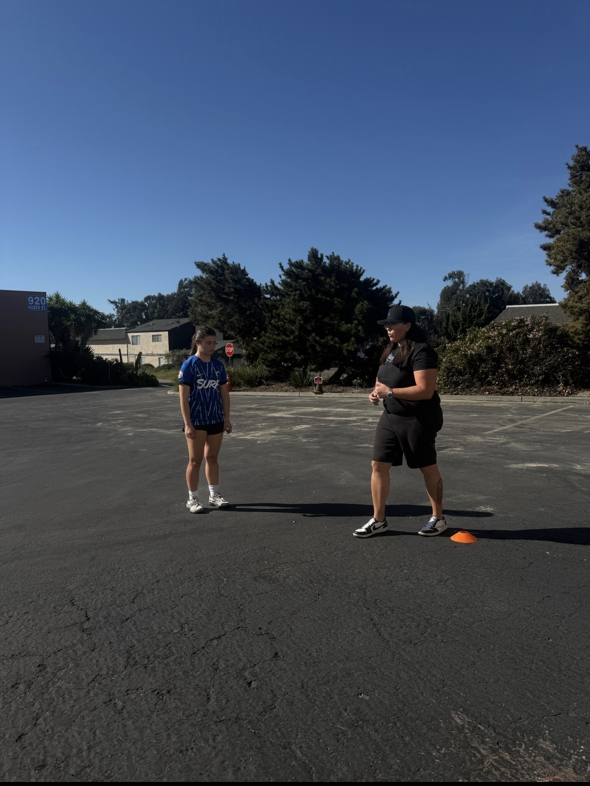 Coach Katrina running cone footwork drills with a youth soccer athlete