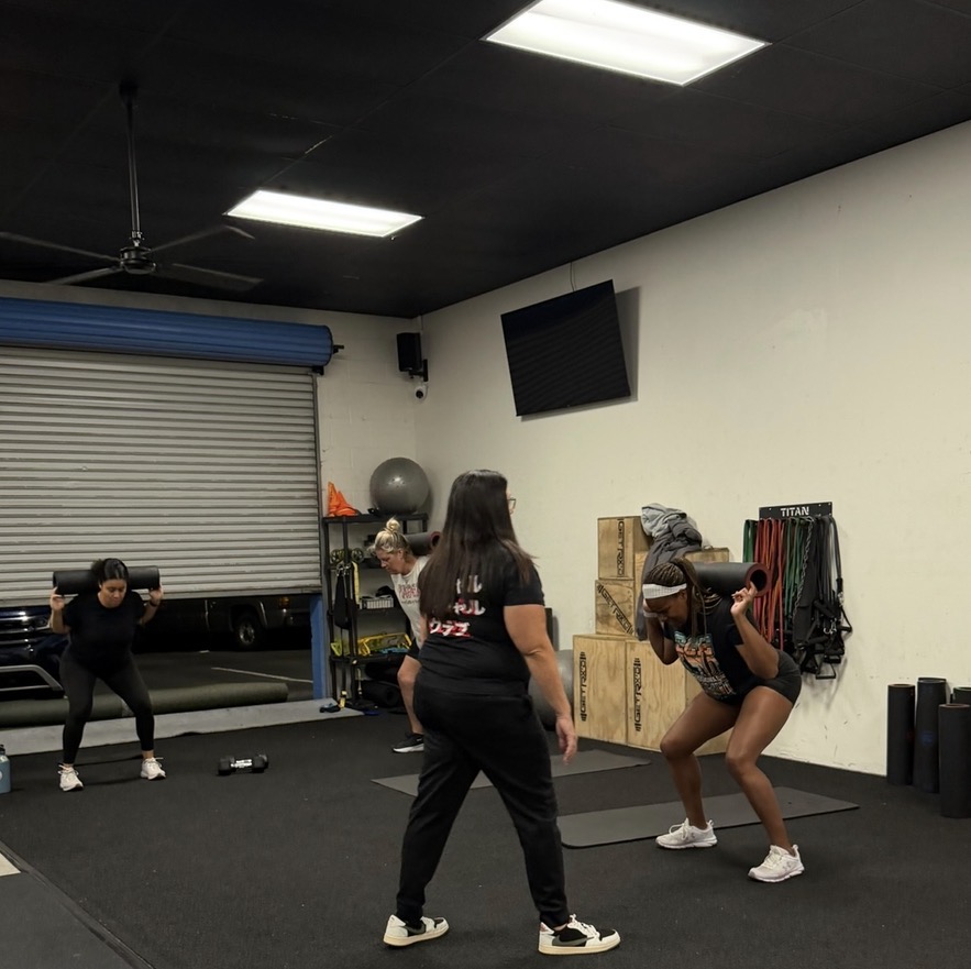Coached squat work during Becoming Her training
