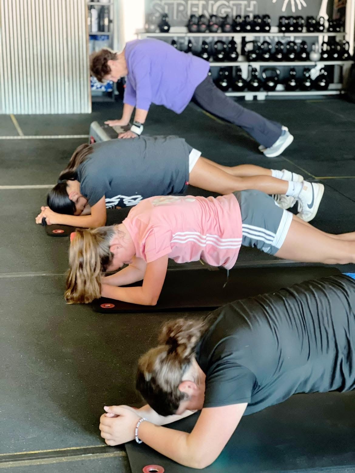 Plank holds with the Becoming Her crew